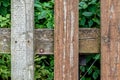 An old wooden fence made of grayed slats with paint faded in the sun Royalty Free Stock Photo