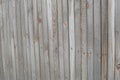 Old wooden fence made of narrow planks