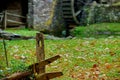 Old wooden fence post and the paddle wheel of an old grist mill Royalty Free Stock Photo