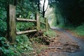 an old wooden fence on the side of a dirt road Royalty Free Stock Photo