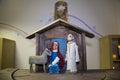 Old wooden figures of a man with a beard, a woman with a baby, a sheep in a wooden house. Christmas, Christianity, Royalty Free Stock Photo