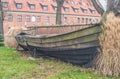 Old wooden fishboat wreck in a grass on land Royalty Free Stock Photo