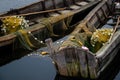 old wooden fisherman boat with a paddle. Inside is a fishing net and other fishing gear. A good way to make money for the Royalty Free Stock Photo