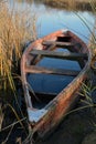Old wooden fishing boat on autumn lake coast Royalty Free Stock Photo