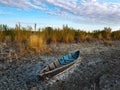 Old wooden fishing boat on a dry lake. Autumn landscape Royalty Free Stock Photo