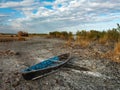 Old wooden fishing boat on a dry lake. Autumn landscape Royalty Free Stock Photo