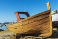 Old wooden fishing boat moored on the beach in Italy Royalty Free Stock Photo