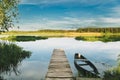 Old Wooden Fishing Boat Near Pier In Summer Lake Or River. Beautiful Summer Sunny Day Or Evening. Forsaken Boat. Russian Royalty Free Stock Photo