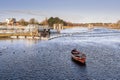 Old wooden fishing boat. River Corrib, Galway city, Ireland, Warm sunny day. Nobody. Blue cloudy sky and water. Outdoor activity Royalty Free Stock Photo