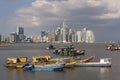 Old wooden fishing boats in front of the skyline of panama city panama