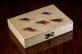 Old Wooden Fishing Fly Box with Salmon Flies on a Wooden Table Top Royalty Free Stock Photo