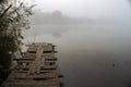 Old wooden fishing pier. Foggy morning on the lake Royalty Free Stock Photo