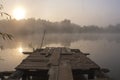 Old wooden fishing pier. Foggy morning on the lake Royalty Free Stock Photo