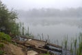 Old wooden fishing pier. Foggy morning on the lake Royalty Free Stock Photo