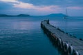 Old wooden fishing pier goes into the sea on sunset. Resort city Novyi Svet, Crimea Royalty Free Stock Photo