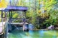 Old wooden floodgate at a small river