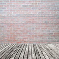 Old wooden floor on brick wall grung background