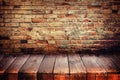 Old wooden floor with brick wall. Royalty Free Stock Photo