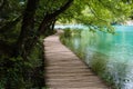 Old wooden footpath with blue water grass and trees in National Park Plitvice Lakes in Croatia Royalty Free Stock Photo