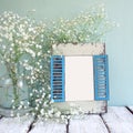 Old wooden frame next to white flowers on wooden table. template, ready to put photography Royalty Free Stock Photo