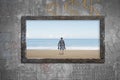 Old wooden frame window sea view with barefoot man Royalty Free Stock Photo