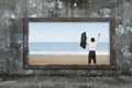 Old wooden frame window sea view with cheering man Royalty Free Stock Photo