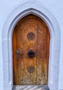Old wooden front door with a decorative door knocker Royalty Free Stock Photo