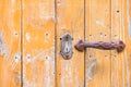 Detail view of old wood door with rusty handgrip and keyhole