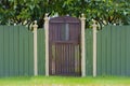 Old Wooden Garden Gate and Green Fence Royalty Free Stock Photo