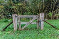 Old wooden gate closed with a chain and a rusty padlock Royalty Free Stock Photo