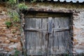 Old wooden gate doors and stone wall Royalty Free Stock Photo