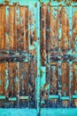 Old wooden gate doorway with blue paint peeling off Royalty Free Stock Photo