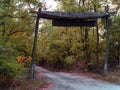 Old wooden gate at the entrance to the autumn forest Royalty Free Stock Photo