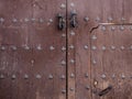 Old wooden gate fixed with   brass rivets in Cordoba, Andalusia, Spain Royalty Free Stock Photo