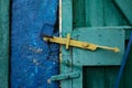 The old wooden gate is locked by an equally old rusty padlock. Royalty Free Stock Photo