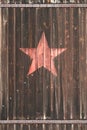 Old wooden gate with soviet star
