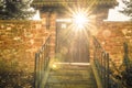 Old wooden gate with sun rays shining through