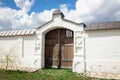 Old wooden gate in white stone wall Royalty Free Stock Photo