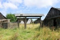 Old wooden gates in abandoned village overgrown by grass Royalty Free Stock Photo