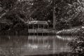 Old wooden gazebo on the shore of the lake in the photo in retro style Royalty Free Stock Photo