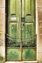 Old wooden green door with wrought iron details Royalty Free Stock Photo