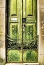 Old wooden green door with wrought iron details Royalty Free Stock Photo