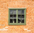 Old wooden green window in a seamless medieval brick wall