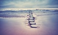 Old wooden groyne on a beach.