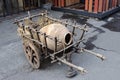 Old wooden handcart with big pitcher