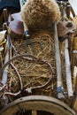 Old wooden handcart full of straw and agricultural tools