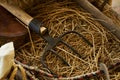 Old wooden handcart full of straw and agricultural tools