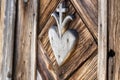 old wooden hart with cross pattern carved on wayside shrine door Royalty Free Stock Photo