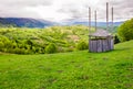 Old wooden hay shed on grassy hillside