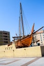 Old wooden boat called a Dhow outside the Dubai museum in UAE